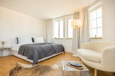 a white bedroom with a bed and a couch at Apartment Musala N 03 in Varna City