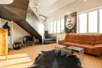 a living room with a couch and a staircase at Apartment Musala N 03 in Varna City