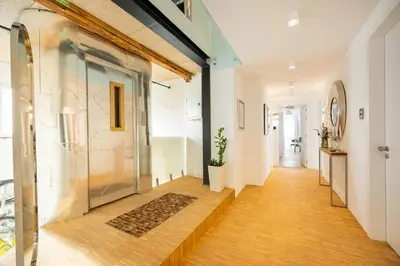 a hallway with a glass door and wooden floors at Apartment Musala N 03 in Varna City