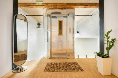 a glass door in a hallway with a mirror at Apartment Musala N 03 in Varna City
