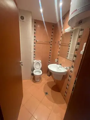 a bathroom with a toilet and a sink at Lozenetz Beach Apartments in Lozenets