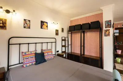 a bedroom with a bed and some pictures on the wall at Zen Studio - Oasis Beach Club in Lozenets