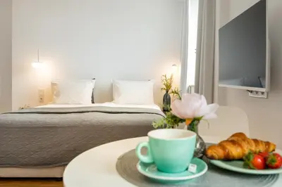 a room with a bed and a table with a cup of coffee at Apartment Musala N 04 in Varna City