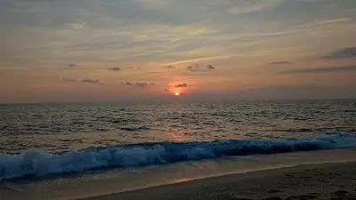 a sunset on the beach with the ocean at Holiday Fort Golf Club & Orchid Fort Noks MIA in Sunny Beach