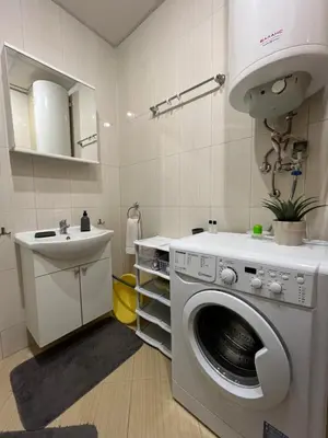 a bathroom with a washing machine and a sink at Holiday Fort Golf Club & Orchid Fort Noks MIA in Sunny Beach