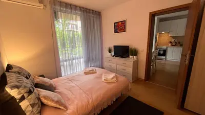 a bedroom with a bed and a large window at Holiday Fort Golf Club & Orchid Fort Noks MIA in Sunny Beach