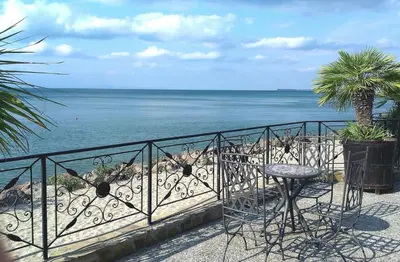 a balcony with a table and a view of the ocean at Menada Atrium Beach Apartments in Elenite