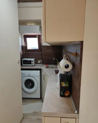 a small kitchen with a washing machine and a washer at Dream Loft in the center of Varna in Varna City
