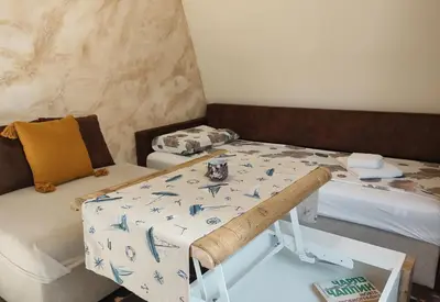 a small room with two beds and a table at Dream Loft in the center of Varna in Varna City