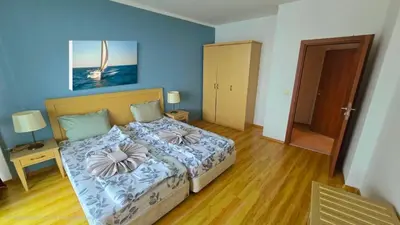 a bedroom with a bed with two pillows on it at Апартамент Del View гр Приморско in Primorsko
