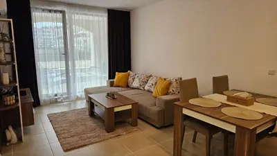 a living room with a couch and a table at Vladan apartments in Sozopol
