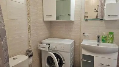 a bathroom with a washing machine and a sink at Vladan apartments in Sozopol