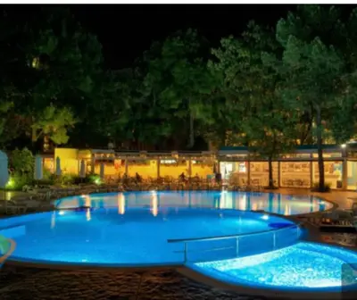a large blue swimming pool at night at Cozy private studios Excelsior Sunny Beach in Sunny Beach