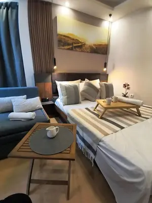 a hotel room with two beds and a couch at Cozy private studios Excelsior Sunny Beach in Sunny Beach