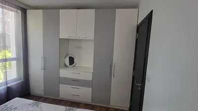 a bedroom with a cupboard with a tv on it at Синя пеперуда Blue butterfly in Primorsko