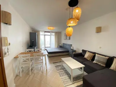 a living room with a couch and a table at Santa Marina Sun&Sea Haven in Sozopol