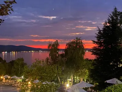 a view of a lake at night with a sunset at Santa Marina Sun&Sea Haven in Sozopol