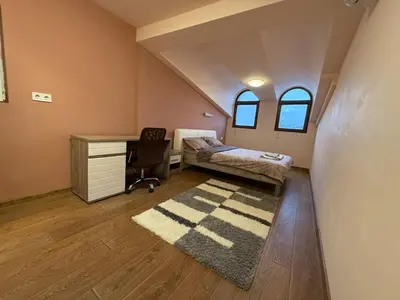 a bedroom with a desk and a bed and a chair at Two-Bedroom Apartment in the Heart of Burgas, Bogoridi Street in Burgas City