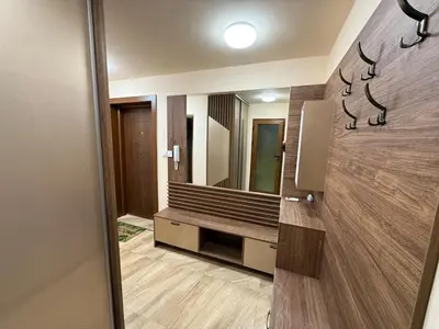 a bathroom with a bench and a mirror at Two-Bedroom Apartment in the Heart of Burgas, Bogoridi Street in Burgas City