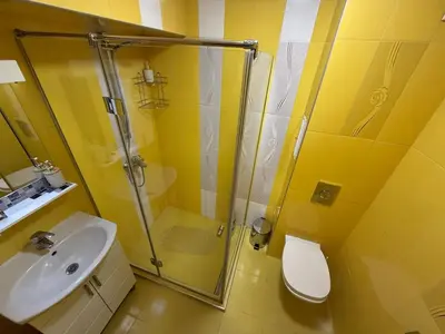a bathroom with a shower and a sink and a toilet at Two-Bedroom Apartment in the Heart of Burgas, Bogoridi Street in Burgas City