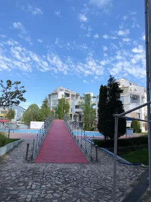a red carpet on a walkway with some buildings at Elit 2 Apartment in Sunny Beach