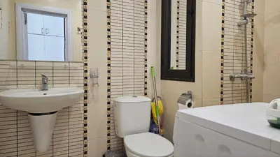 a bathroom with a toilet and a sink at Vladan apartments in Sozopol