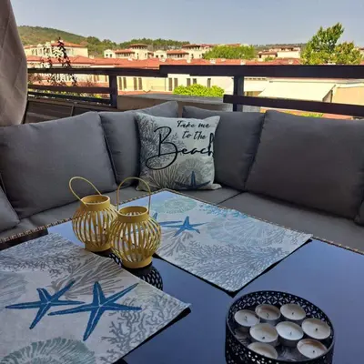 a couch with two vases on top of a table at Vladan apartments in Sozopol