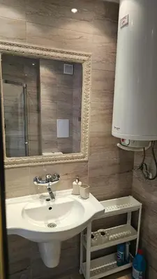 a bathroom with a sink and a mirror at Vladan apartments in Sozopol