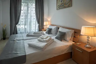 a bedroom with two beds with towels on them at Apartment NORA in Sunny Beach