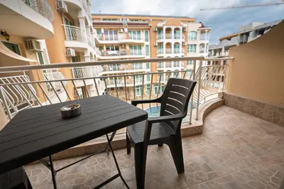 a black table and chair on a balcony at Apartment NORA in Sunny Beach