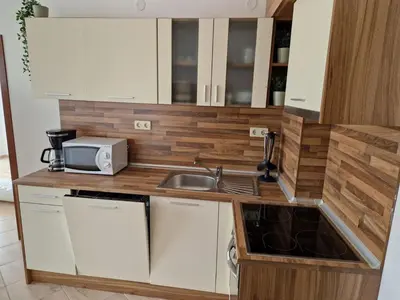 a small kitchen with a sink and a microwave at SunBreeze Living Apartments in Byala