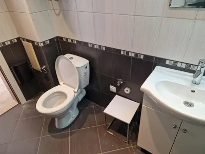 a bathroom with a toilet and a sink at SunBreeze Living Apartments in Byala
