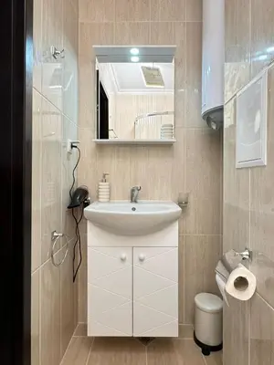 a bathroom with a sink and a mirror and a toilet at SeaView Etara IV Apartment in Sveti Vlas in Sveti Vlas