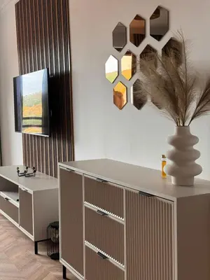 a living room with a dresser and a vase with a plant at SeaView Etara IV Apartment in Sveti Vlas in Sveti Vlas