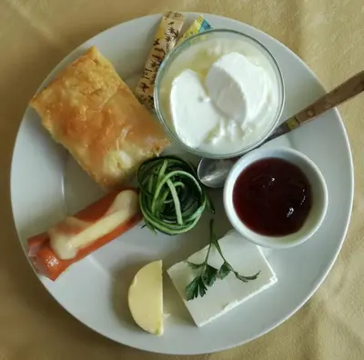 a plate of food with cheese and other foods on it at Hotel Continental in Kiten
