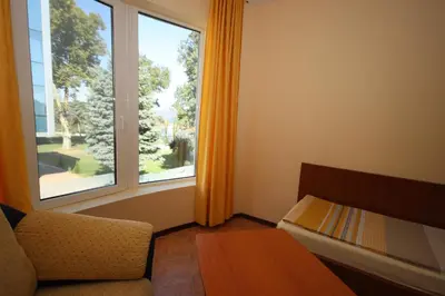 a room with a couch and a large window at Hotel Continental in Kiten