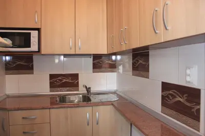 a kitchen with a sink and a microwave at Megi Apartments in Sozopol