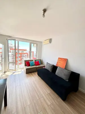 a living room with a couch and a large window at 17 pools in Fort Noks Grand in Sveti Vlas