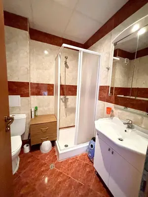 a bathroom with a shower and a toilet and a sink at 17 pools in Fort Noks Grand in Sveti Vlas
