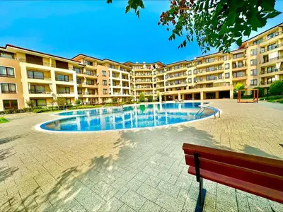 a swimming pool in front of a large apartment building at Menada Sea Dreams Apartments in Sveti Vlas