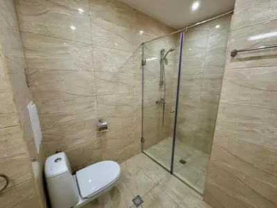 a bathroom with a shower with a toilet and a glass shower stall at Menada Sea Dreams Apartments in Sveti Vlas