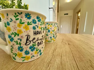 a coffee cup with a have a beautiful day written on it at Menada Sea Dreams Apartments in Sveti Vlas