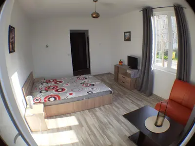 a bedroom with a bed and a table and a mirror at Sunshine Byala in Byala