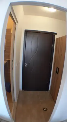 a large black door in a room with a mirror at Sunshine Byala in Byala