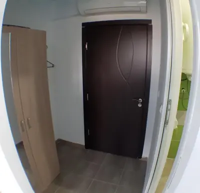 a black door in a room with a mirror at Sunshine in Byala