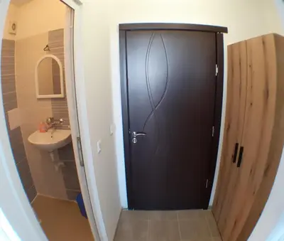 a black door in a bathroom with a sink at Sunshine in Byala