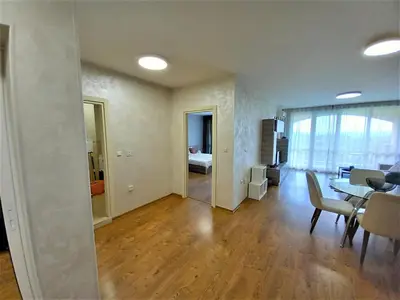 a living room with a table and a dining room at Sunset in Chernomorets