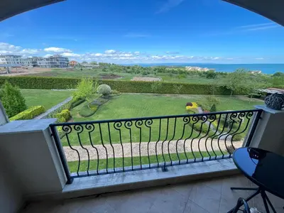 a balcony with a view of a garden at Sunset in Chernomorets