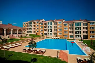 a large apartment complex with a large swimming pool at Sunset in Chernomorets