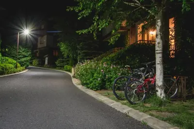 a group of bikes parked next to a house at night at Marina Trio in Sozopol